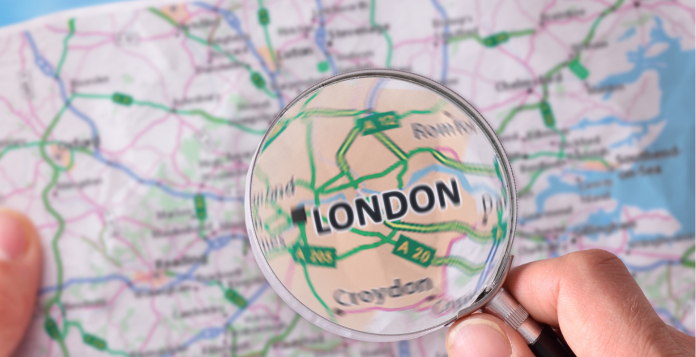 Map of UK with a magnifying glass over London 